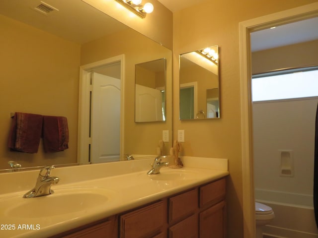 bathroom featuring vanity and toilet