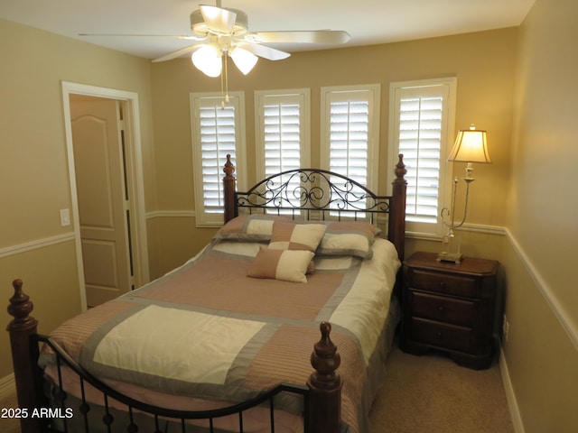 bedroom featuring multiple windows, carpet, and ceiling fan