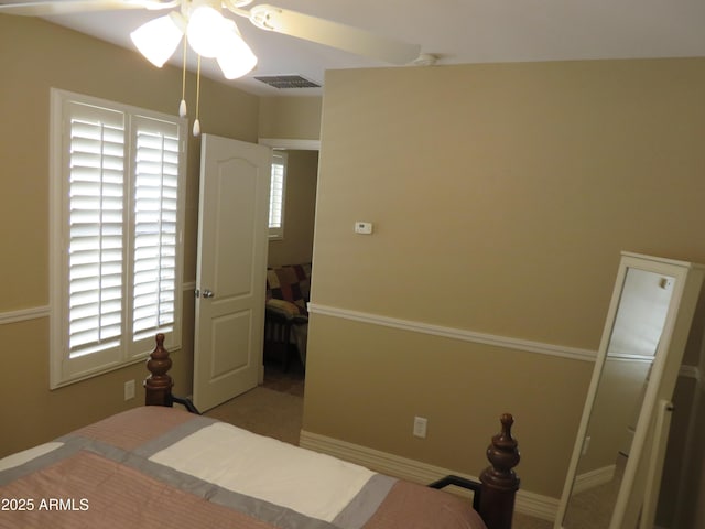 unfurnished bedroom with ceiling fan and multiple windows