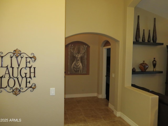 hall with tile patterned floors