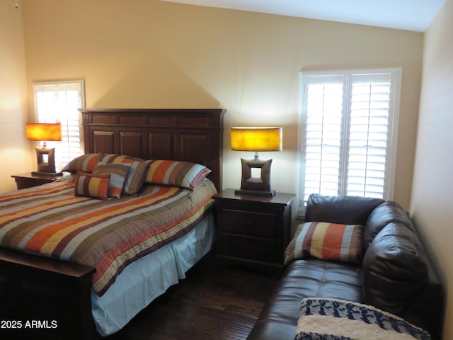 bedroom with multiple windows, lofted ceiling, and dark hardwood / wood-style floors