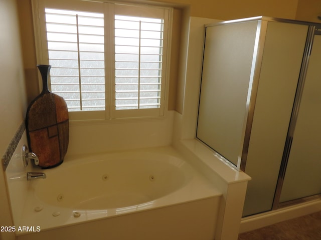 bathroom featuring shower with separate bathtub