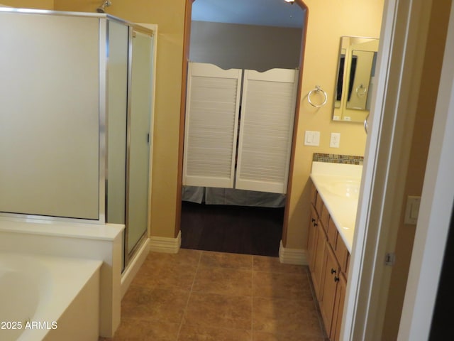 bathroom with tile patterned floors, vanity, and separate shower and tub