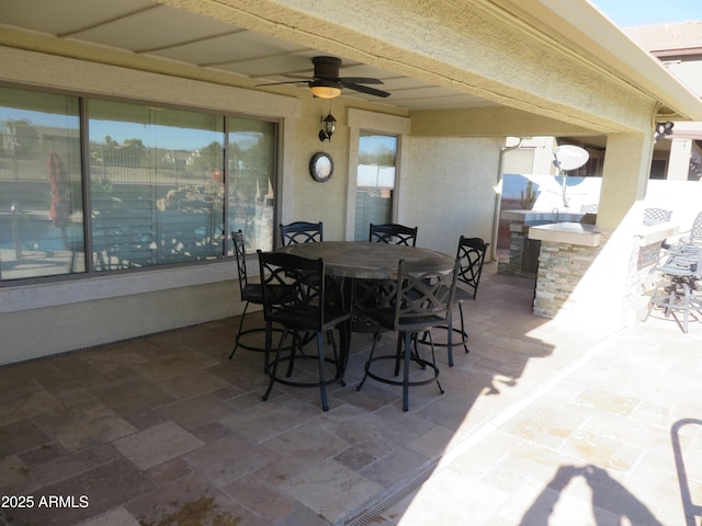 view of patio with an outdoor bar and ceiling fan