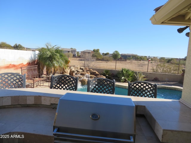 view of patio featuring a fenced in pool and grilling area