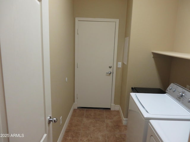 laundry room with tile patterned flooring and washing machine and clothes dryer