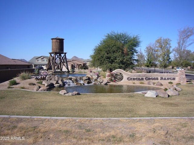 community sign featuring a yard