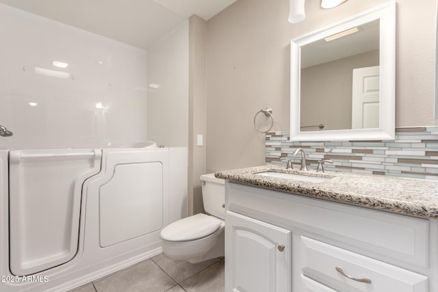 full bathroom featuring tile patterned flooring, toilet, tasteful backsplash, and vanity