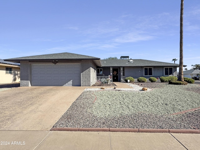 single story home with brick siding, concrete driveway, and an attached garage