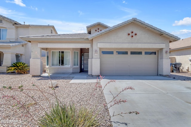 11630 W Jefferson St, Avondale, AZ 85323 - view of front of home featuring concrete driveway, a garage, stucco siding, and a tile roof