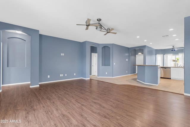 11630 W Jefferson St, Avondale, AZ 85323 - unfurnished living room featuring a ceiling fan, arched walkways, light wood-type flooring, and recessed lighting