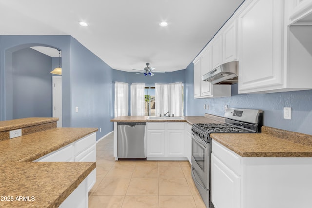 11630 W Jefferson St, Avondale, AZ 85323 - kitchen with appliances with stainless steel finishes, under cabinet range hood, ceiling fan, light tile patterned floors, and white cabinetry
