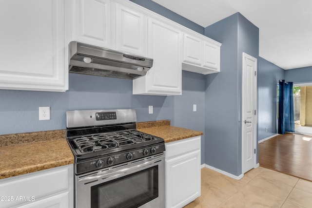 11630 W Jefferson St, Avondale, AZ 85323 - kitchen with under cabinet range hood, gas range, white cabinetry, and light tile patterned floors
