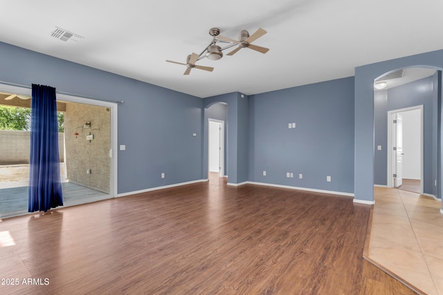 11630 W Jefferson St, Avondale, AZ 85323 - spare room featuring arched walkways, ceiling fan, and wood finished floors