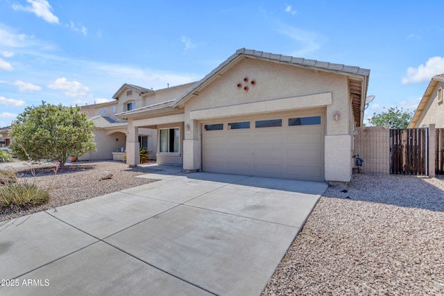 11630 W Jefferson St, Avondale, AZ 85323 - view of front of home with a garage, stucco siding, concrete driveway, and a gate