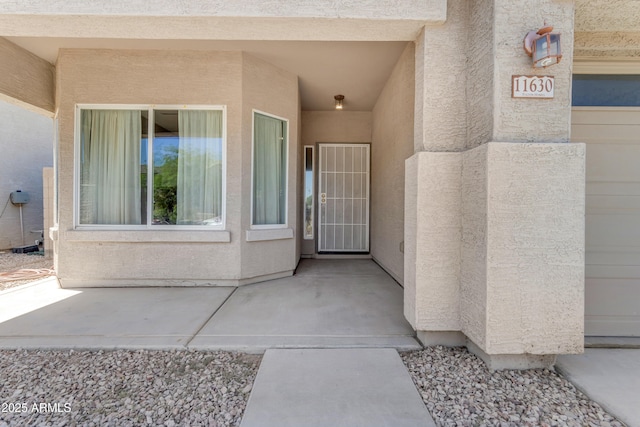 11630 W Jefferson St, Avondale, AZ 85323 - view of exterior entry with stucco siding and a patio