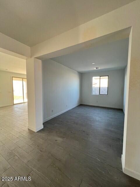 empty room with dark wood-type flooring