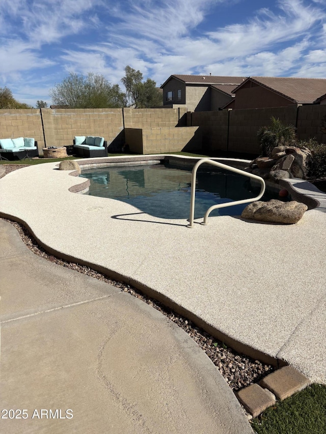 view of pool with a patio, a fenced backyard, an outdoor living space, and a fenced in pool