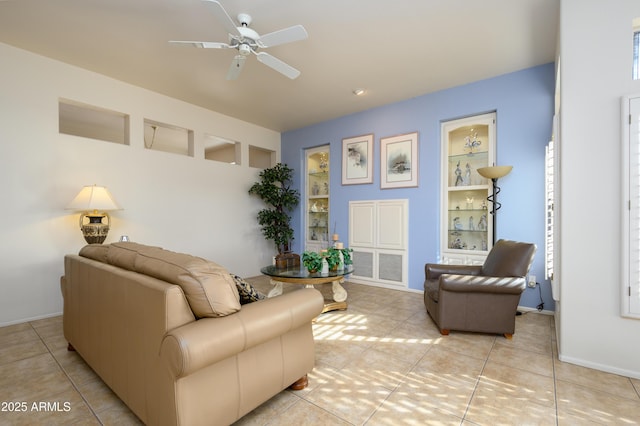 tiled living room featuring built in features and ceiling fan