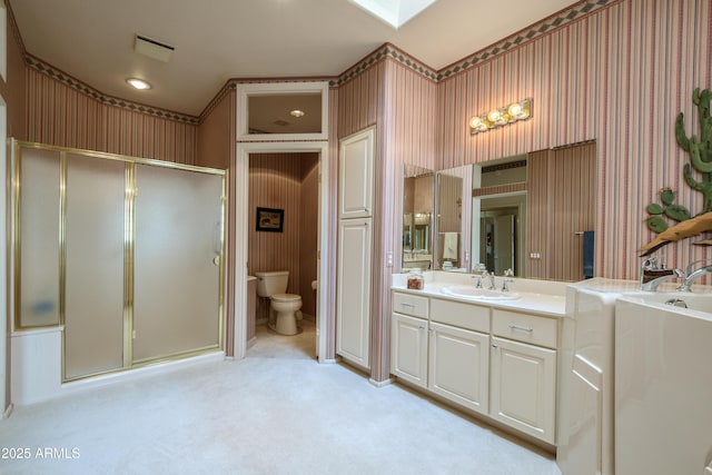 full bathroom with vanity, shower with separate bathtub, and toilet