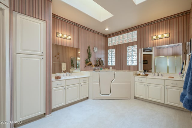 bathroom featuring vanity, plus walk in shower, and a skylight