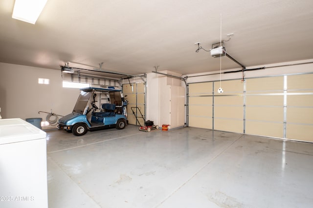 garage with a garage door opener and washer / clothes dryer