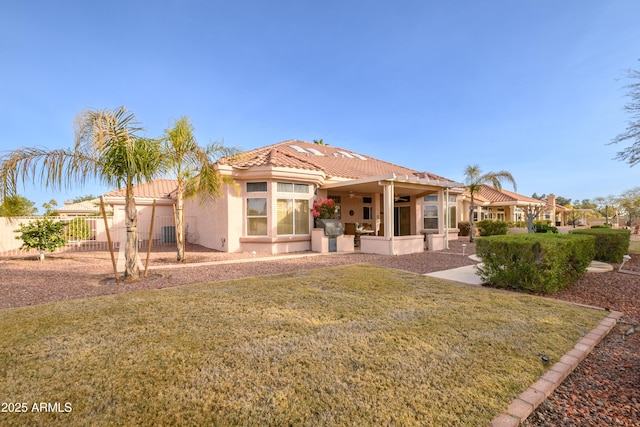 rear view of property featuring a yard