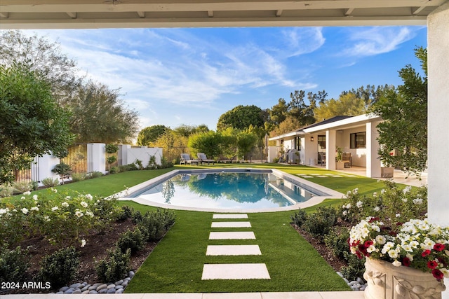 view of swimming pool with a yard and a patio