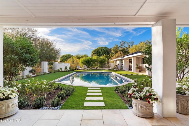 view of swimming pool featuring a lawn