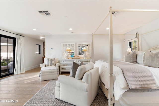 bedroom with access to exterior and light hardwood / wood-style flooring