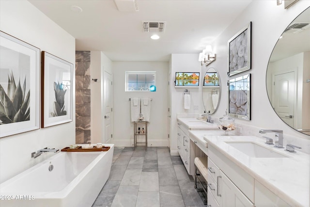 bathroom featuring a washtub, vanity, a notable chandelier, and tile patterned flooring