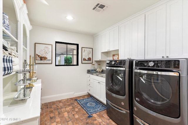 laundry area with cabinets and washing machine and dryer