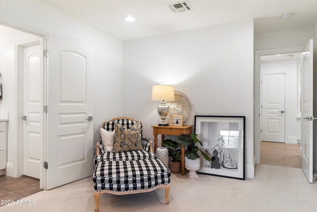 sitting room featuring light colored carpet