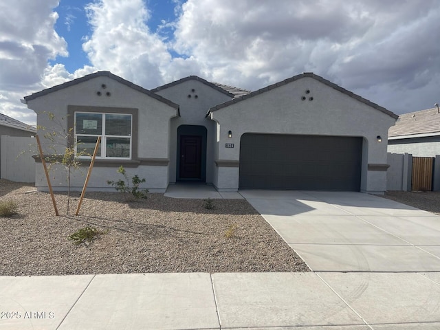 1324 S Mullberry St, Florence, AZ 85132 - ranch-style house featuring an attached garage, stucco siding, concrete driveway, and fence
