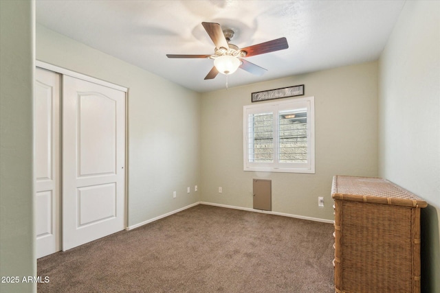 unfurnished bedroom with carpet, a closet, and ceiling fan