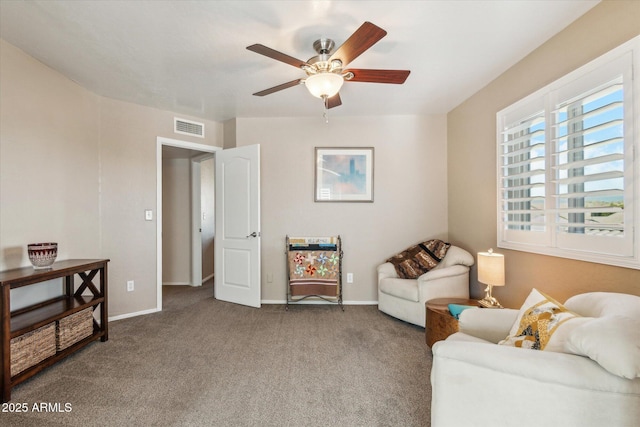 living area featuring carpet and ceiling fan