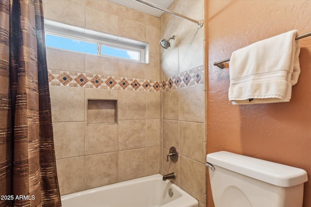 bathroom featuring shower / bath combo and toilet