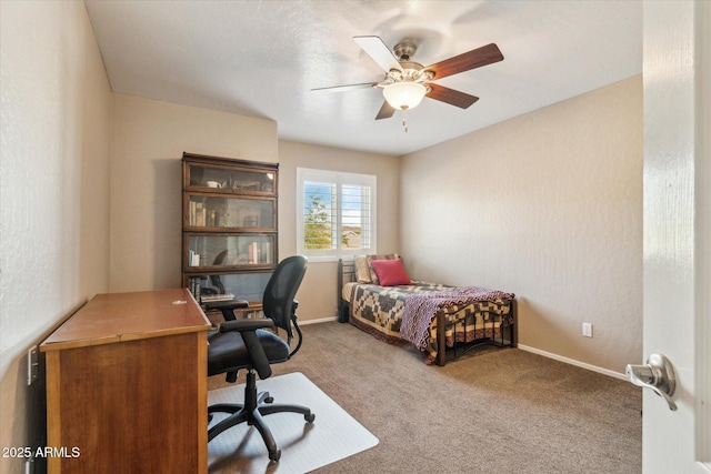 bedroom featuring ceiling fan and carpet