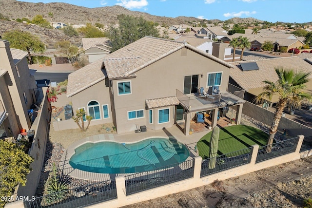 back of house with a mountain view, a patio, and a fenced in pool