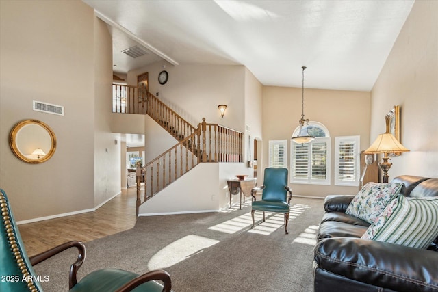 carpeted living room with a high ceiling