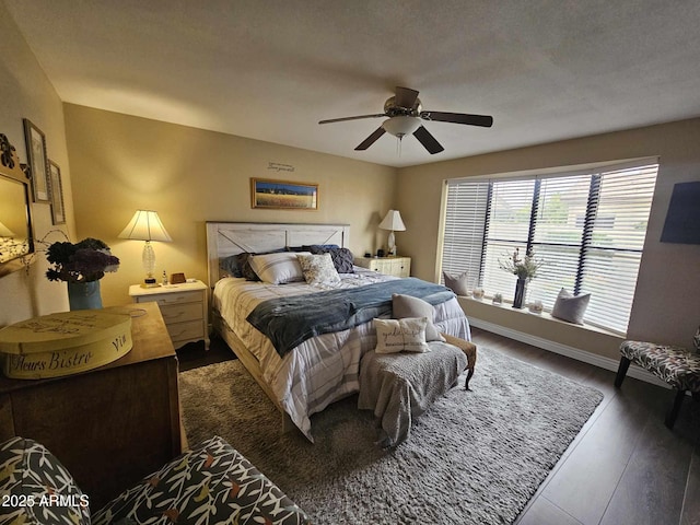 bedroom featuring a textured ceiling, dark hardwood / wood-style flooring, and ceiling fan