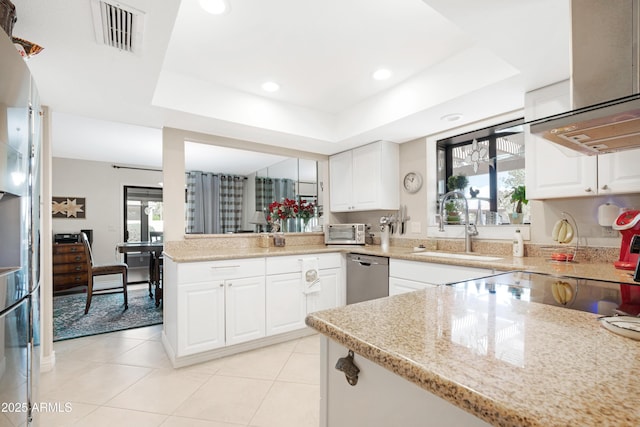 kitchen featuring sink, a raised ceiling, white cabinetry, and stainless steel appliances