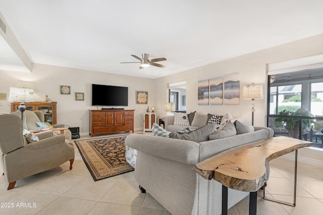 tiled living room with ceiling fan