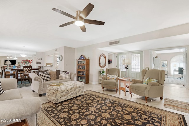 tiled living room with ceiling fan