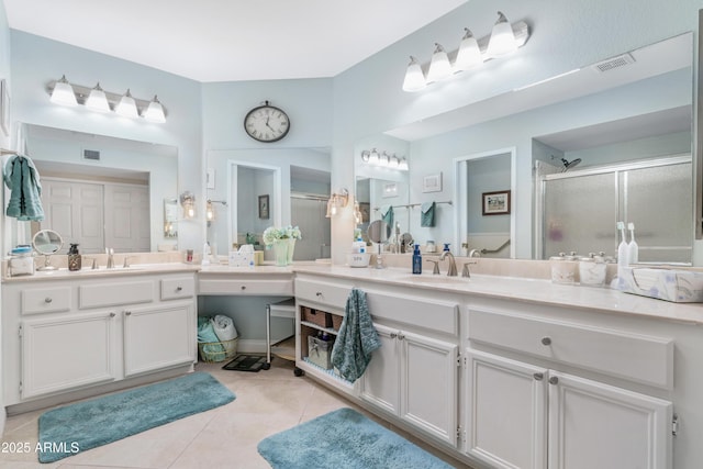 bathroom with tile patterned floors, vanity, and an enclosed shower