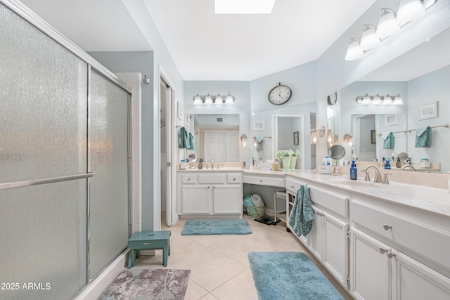 bathroom with tile patterned flooring, vanity, and an enclosed shower