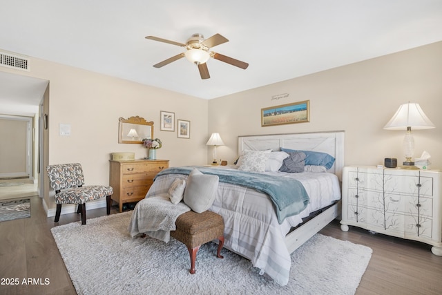 bedroom with ceiling fan and dark hardwood / wood-style floors