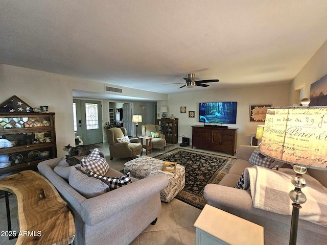 tiled living room with ceiling fan