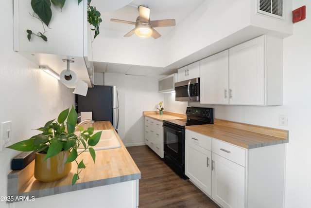 805 N 4th Ave Unit 701, Phoenix, AZ 85003 - kitchen featuring wood counters, black range with electric cooktop, stainless steel microwave, and freestanding refrigerator