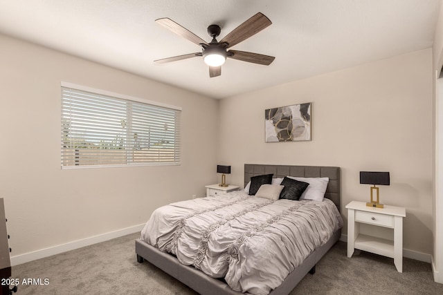 carpeted bedroom with baseboards and a ceiling fan